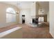 Open living room has high ceilings, fireplace, large windows, and neutral carpet at 902 Possum Hill St, Henderson, NV 89014