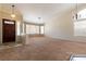 Spacious living room features an elegant chandelier, neutral carpet, and many large windows at 902 Possum Hill St, Henderson, NV 89014