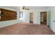 Spacious bedroom with carpet flooring, ceiling fan, closet, and modern wall decor at 902 Possum Hill St, Henderson, NV 89014