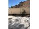 Enclosed backyard offering a concrete patio area, rock detail, and a privacy fence at 908 Shining Rose Pl, Henderson, NV 89052