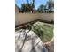 Well-maintained backyard featuring a concrete patio area and lush artificial grass at 908 Shining Rose Pl, Henderson, NV 89052