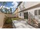 Private backyard featuring a concrete patio, low maintenance artificial lawn, and a slider to the home's interior at 908 Shining Rose Pl, Henderson, NV 89052