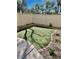 A low maintenance backyard featuring artificial turf, rock landscaping, and flower beds at 908 Shining Rose Pl, Henderson, NV 89052