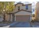 Charming two-story home featuring a two-car garage, neutral stucco, and manicured landscaping at 908 Shining Rose Pl, Henderson, NV 89052