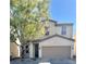 Charming two-story home with a two-car garage, desert landscaping, and mature shade tree at 908 Shining Rose Pl, Henderson, NV 89052