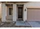 Inviting front entrance with a dark wood door and a covered porch area at 908 Shining Rose Pl, Henderson, NV 89052