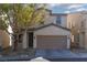 Charming two-story home with a two-car garage and well-maintained front yard at 908 Shining Rose Pl, Henderson, NV 89052