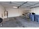 Spacious garage featuring a water heater, storage racks, and blue recycle bins at 908 Shining Rose Pl, Henderson, NV 89052
