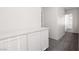 Upstairs hallway with gray carpet, a storage nook, and views into the other rooms at 908 Shining Rose Pl, Henderson, NV 89052