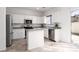 Stylish kitchen with white cabinets, stainless steel appliances, and granite countertops at 908 Shining Rose Pl, Henderson, NV 89052