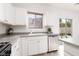 Well-lit kitchen featuring stainless steel dishwasher, ample counter space, and a garden window at 908 Shining Rose Pl, Henderson, NV 89052