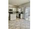 Bright kitchen featuring white cabinetry, stainless steel appliances, and neutral countertops at 908 Shining Rose Pl, Henderson, NV 89052