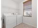 Functional laundry room with washer, dryer, and window with a view at 908 Shining Rose Pl, Henderson, NV 89052
