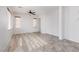 Bright and airy living room featuring a ceiling fan, lots of light, and tile and wood floors at 908 Shining Rose Pl, Henderson, NV 89052