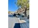 View of homes on street, featuring low maintenance landscaping and mature shade trees at 908 Shining Rose Pl, Henderson, NV 89052