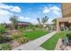 Spacious backyard with lush artificial turf, walkway, and a charming covered patio area at 9237 Quail Ridge Dr, Las Vegas, NV 89134