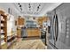 Functional kitchen with breakfast bar, stainless steel appliances, and custom wood cabinetry at 9237 Quail Ridge Dr, Las Vegas, NV 89134