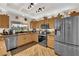 Traditional kitchen features oak cabinetry, stainless steel appliances, and a garden view at 9237 Quail Ridge Dr, Las Vegas, NV 89134