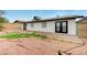 The backyard, landscaped with gravel and a small patio, features the home's exterior at , Henderson, NV 89015