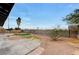 The backyard is landscaped with gravel and a small patio, featuring a palm tree at , Henderson, NV 89015