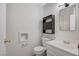 This bathroom has a toilet, sink, mirror, shelves, and towel rack at , Henderson, NV 89015