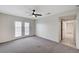 Bedroom featuring ceiling fan, neutral carpet, hallway access, and french doors at , Henderson, NV 89015