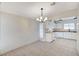 Bright dining area with tile floors and a view into a kitchen with white cabinets and appliances at , Henderson, NV 89015