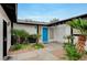 Inviting home entrance with a bright blue door, desert landscaping, and black accents at , Henderson, NV 89015