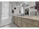 Bright bathroom featuring double sinks, neutral countertops, and a view of the walk-in closet at 10017 Bundella Dr, Las Vegas, NV 89134