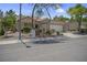 Inviting single-story home with a two-car garage, desert landscaping, and a tiled roof at 10017 Bundella Dr, Las Vegas, NV 89134