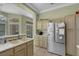 Bright kitchen featuring stainless steel refrigerator, tile flooring, and light wood cabinets at 10017 Bundella Dr, Las Vegas, NV 89134