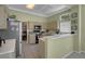 Well-lit kitchen with tiled floors, appliances, and a breakfast bar at 10017 Bundella Dr, Las Vegas, NV 89134
