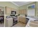 Bright kitchen with tiled floors, appliances, and view to the dining area at 10017 Bundella Dr, Las Vegas, NV 89134