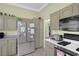 Bright kitchen featuring stainless steel refrigerator and oven, tile flooring at 10017 Bundella Dr, Las Vegas, NV 89134