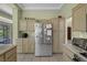 Bright kitchen featuring stainless steel refrigerator, and breakfast bar with countertop at 10017 Bundella Dr, Las Vegas, NV 89134