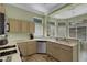 Bright kitchen featuring tile flooring, light wood cabinets, and stainless steel dishwasher at 10017 Bundella Dr, Las Vegas, NV 89134