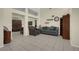 Comfortable living room with tile flooring, large sofa, and accent chair at 10017 Bundella Dr, Las Vegas, NV 89134