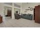 Cozy living room featuring neutral tile flooring, decorative shelving, and comfortable seating at 10017 Bundella Dr, Las Vegas, NV 89134