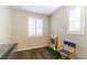 Well-lit bedroom with two windows and hardwood floors perfect for flexible use at 10711 Silver Pond Ave, Las Vegas, NV 89135