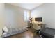 Cozy bedroom with natural light, a functional desk setup, and wood flooring at 10711 Silver Pond Ave, Las Vegas, NV 89135