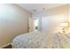 Comfortable bedroom featuring neutral colors, a patterned bedspread, and sliding closet doors at 10711 Silver Pond Ave, Las Vegas, NV 89135
