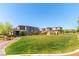Beautiful community park with grassy areas, landscaping, and walking paths surrounded by homes at 10711 Silver Pond Ave, Las Vegas, NV 89135