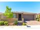 Charming single-story home featuring a low wall, front garden, and a two-car garage at 10711 Silver Pond Ave, Las Vegas, NV 89135
