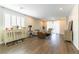 Open-concept living room boasts hardwood floors, light-filled windows and neutral wall colors at 10711 Silver Pond Ave, Las Vegas, NV 89135