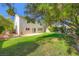 Large backyard with green grass, patio, and mature landscaping at 10716 Aire Dr, Las Vegas, NV 89144