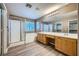 Well-lit bathroom with double sinks, separate shower, soaking tub, and stylish flooring at 10716 Aire Dr, Las Vegas, NV 89144