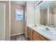 Bright bathroom features double sinks, wood-look flooring, and a window view at 10716 Aire Dr, Las Vegas, NV 89144