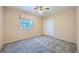 Cozy bedroom featuring neutral walls, carpeted floor, and natural lighting from one window at 10716 Aire Dr, Las Vegas, NV 89144