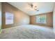 Large bedroom with vaulted ceiling, plush carpet, and dual windows providing ample light at 10716 Aire Dr, Las Vegas, NV 89144