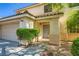 Inviting two-story home featuring a two car garage, tiled roof and charming curb appeal at 10716 Aire Dr, Las Vegas, NV 89144